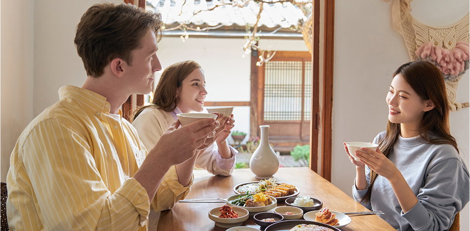 Two women and two men having a meal and chatting happily